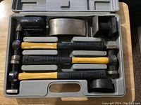 7-piece auto body fender repair hammer set in molded plastic case showing all tools including hammers and dolly pieces