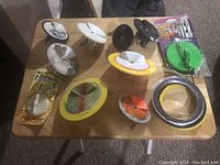 Photo showing 11 Dipsy Diver lures and accessories of various colors arranged on a table.