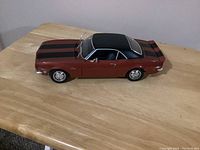 Side view of the Maisto 1968 Chevrolet Camaro Z/28 diecast car showing the color, stripes, and detailed features
