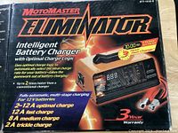 Box front for Motomaster Eliminator Intelligent Battery Charger, showing features and warranty.