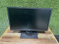 Front view of Acer 21.5-inch monitor powered off on a wooden surface outdoors.