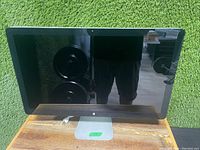 Front view of the Apple 27-inch Thunderbolt Display showing screen and aluminum stand with Apple logo.