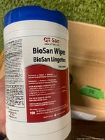 Close-up of label on one container of QT-San BioSan wipes listing active ingredients and usage instructions.