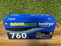 Front and side views of the Brother TN760 toner cartridge box, showing product name and branding.
