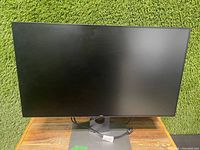 Front view of Dell 27-inch monitor with screen off, showing slim bezel and stand.