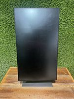 Front view of Dell U2717D monitor in portrait orientation on adjustable stand, showing screen and stand base.