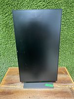 Monitor displayed in portrait (vertical) orientation showing height adjustment and rotation capability.