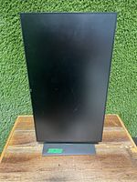 Front view of the Dell monitor in portrait orientation, standing upright on its base showing the full screen and stand.