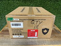 Side view of a case labeled with '40 - PACK Disposable Procedural Masks with Earloops', made in Waterloo ON, quantity 18 cases, details including The Canadian Shield brand, product info and barcode.