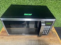 Front view of black Master Chef microwave with digital clock display showing 0:00 and keypad buttons.