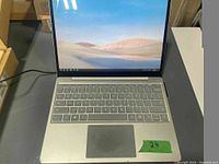 Front view of open laptop showing display, keyboard, trackpad