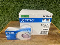 Photo showing the medium size vinyl gloves box and one smaller inner box on a wooden surface