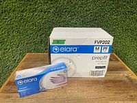 Ten boxes of Elara Prepfilt medium vinyl gloves shown with one box and one open package in front of the large case box