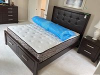 Assembled bed frame with headboard, footboard, Sealy mattress and foam topper rolled on top