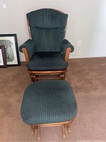 Full view of the glider rocker chair and matching ottoman, showing upholstery and wooden frame.