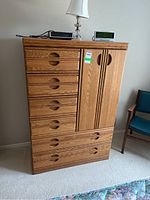 Front view of dresser showing six drawers and cabinet door