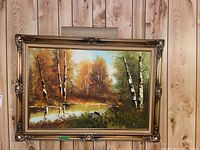 Full view of framed landscape painting depicting birch trees by a pond with autumn colors, showing overall condition and artistic style.
