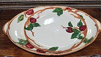 Large oval Franciscan Apple platter with hand-painted apples, leaves, and branches shown on table.