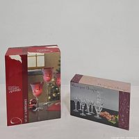 Boxes of the sets included in the lot: Wishes & Wonder frosted hurricane set of 3 and Antique Grape etched wine glass and decanter set