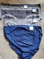 Lot of four XL women's underwear in grey and navy blue, new with tags, some with lace trim