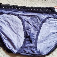 Close-up photo showing purple underwear with lace trim detailing and tags indicating size 3XL.