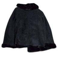 Full back view of the black faux fur jacket showing the plush texture and collar/cuffs trimmed in faux fur.