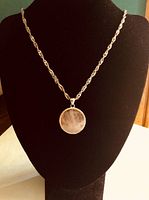 Necklace displayed on black bust showing pendant and chain length.