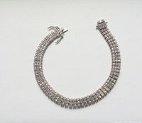 Full view of the sterling silver bracelet showing three rows of clear stones, silver clasp, and overall length and width.
