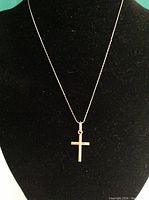 Full view of the 15-inch delicate square link 10K yellow gold necklace with cross pendant displayed on black bust.