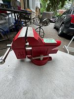 Full side view of red Fuller 4 1/2 inch bench vice showing size markings and solid build.