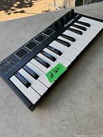 View of the Alesis V Mini keyboard showing the keys, pads, and controls with price tag.