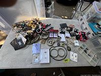 Full assortment of costume jewellery including earrings, bracelets, and brooches spread on a table.