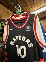 Front view of black Nike Toronto Raptors basketball jersey with white stitched RAPTORS and number 10, Nike logo, and Sun Life patch.