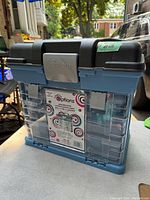 Front view of the closed storage system showing its color, brand label and latch.