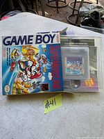 Photo showing Nintendo Game Boy Super Mario Land cartridge, box, and manual on table.