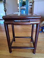 Front angled view showing the square tabletop and leg construction with cutout handle sides.