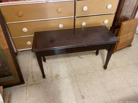 Hall bench angled view showing dark mahogany finish, rectangular seat, and legs