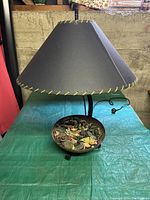 Full view of the vintage table lamp showing black shade with yellow stitching and decorative metal bowl base