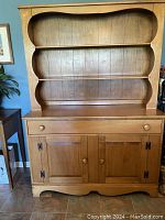 Front view of solid maplewood buffet with attached hutch, showing three open shelves atop the buffet.