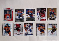 Front view of the 10 Connor McDavid hockey cards laid out in two rows of five, showing various images including McDavid in Edmonton Oilers and Team Canada uniforms.