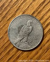 Photo of the reverse side of the 1934 US Silver Peace Dollar showing the eagle perched on a rock with an olive branch and inscriptions.