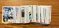 Photo shows a large stack of 1983 Topps baseball cards spread in a row.