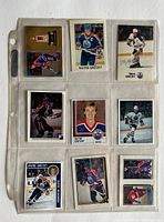 Front sides of nine Wayne Gretzky hockey cards and stickers showing images of Gretzky in Edmonton Oilers uniforms and others.