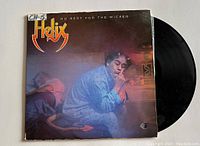 Front cover of Helix vinyl record album titled 'No Rest for the Wicked' featuring a man in pajamas smoking.