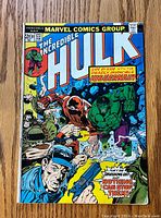 Front cover of The Incredible Hulk comic issue #172 featuring Hulk and Juggernaut fight scene with police officer in foreground.