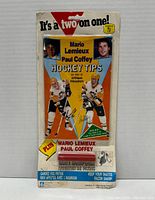 Front view of the sealed 1988-89 Mario Lemieux Paul Coffey Hockey Tips book with skate sharpener in original packaging.