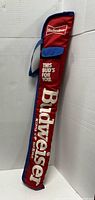 Side view of red and blue Budweiser billiards cue carrying case showing printed logos and text