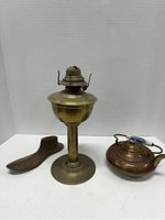 Photo showing lot of three collectible antiques against white background.