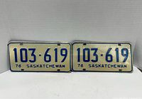 Front view of two matching 1976 Saskatchewan license plates with number 103-619, blue text on white background.