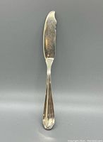 Front view of the sterling silver master butter knife showing the handle design and blade shape